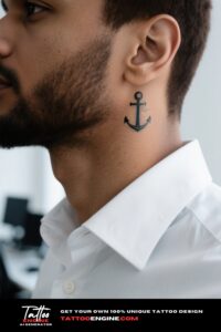 Close-up of a man with a minimalist anchor tattoo, in a white shirt.