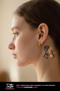 Close-up of a minimalist tiger tattoo behind a woman's ear