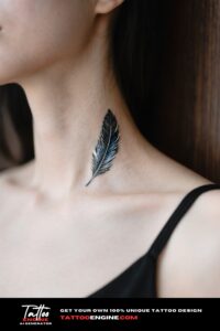 An extreme close-up of a woman's neck with a small feather tattoo, wearing a black top.