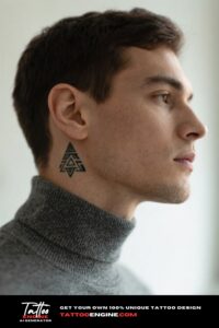 Close-up of a man's neck with a small tribal tattoo below the ear