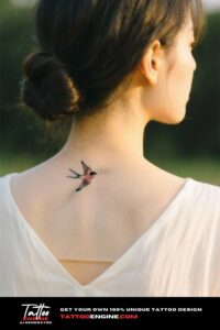 Back of a woman's neck with a bird tattoo and a low bun hairstyle