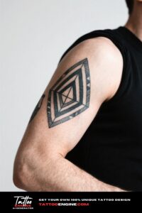 Close-up of a man's forearm with a dynamic geometric tattoo in a black leather jacket.