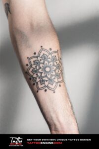 Close-up of a man's inner forearm with a geometric mandala tattoo in a black t-shirt.