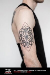 Close-up of a man's forearm with a fractal geometric tattoo in a navy blue shirt.