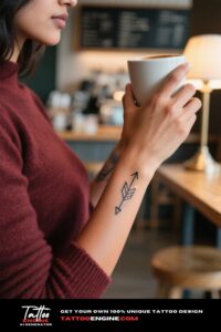 Close-up of a woman's forearm with a geometric arrow tattoo.