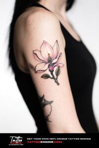 A magnolia flower tattoo on a woman's forearm.