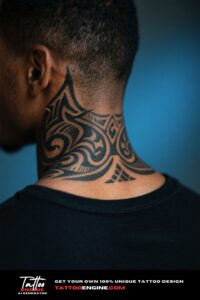 Back of a man's neck with a tribal tattoo, wearing a black t-shirt.