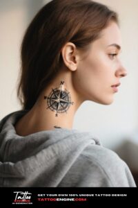 Diagonal view of a woman's neck with a compass tattoo, wearing a grey hoodie.