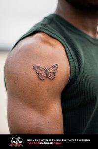 Minimalist butterfly tattoo on medium-brown shoulder, sleeveless tee, natural daylight.