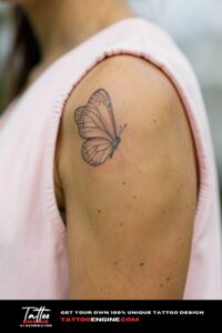 Dotwork butterfly tattoo on tan shoulder, sleeveless pink blouse, overcast daylight.