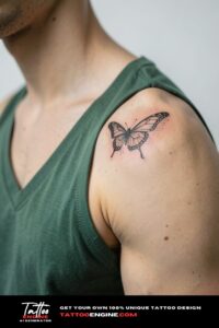 Fine line butterfly tattoo with dotwork on beige shoulder, green v-neck t-shirt wide.