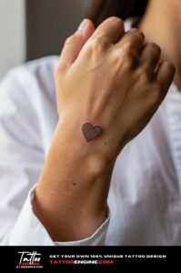 Micro dotwork heart tattoo across middle finger knuckle, subtle on olive skin.