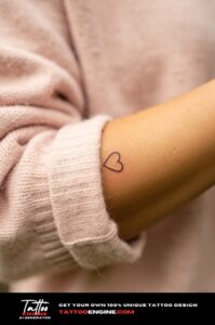 Small single needle heart tattoo on inside of index finger, minimal and subtle.